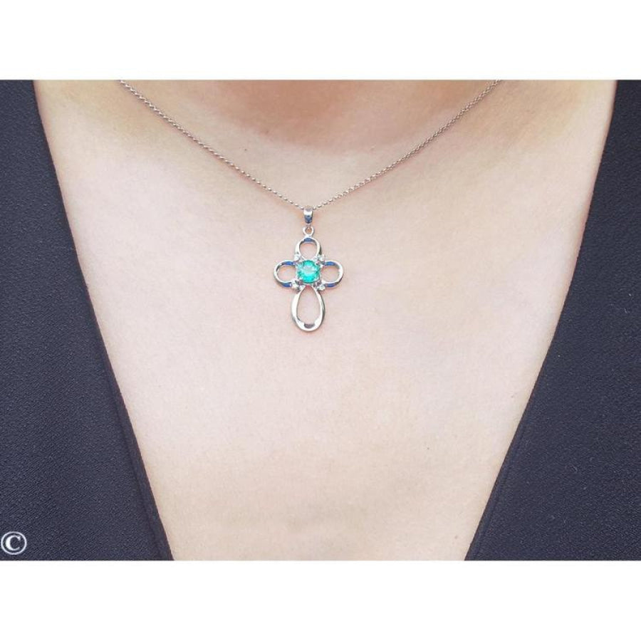 14K white gold cross pendant with a round Colombian emerald and diamond accents on a delicate chain.