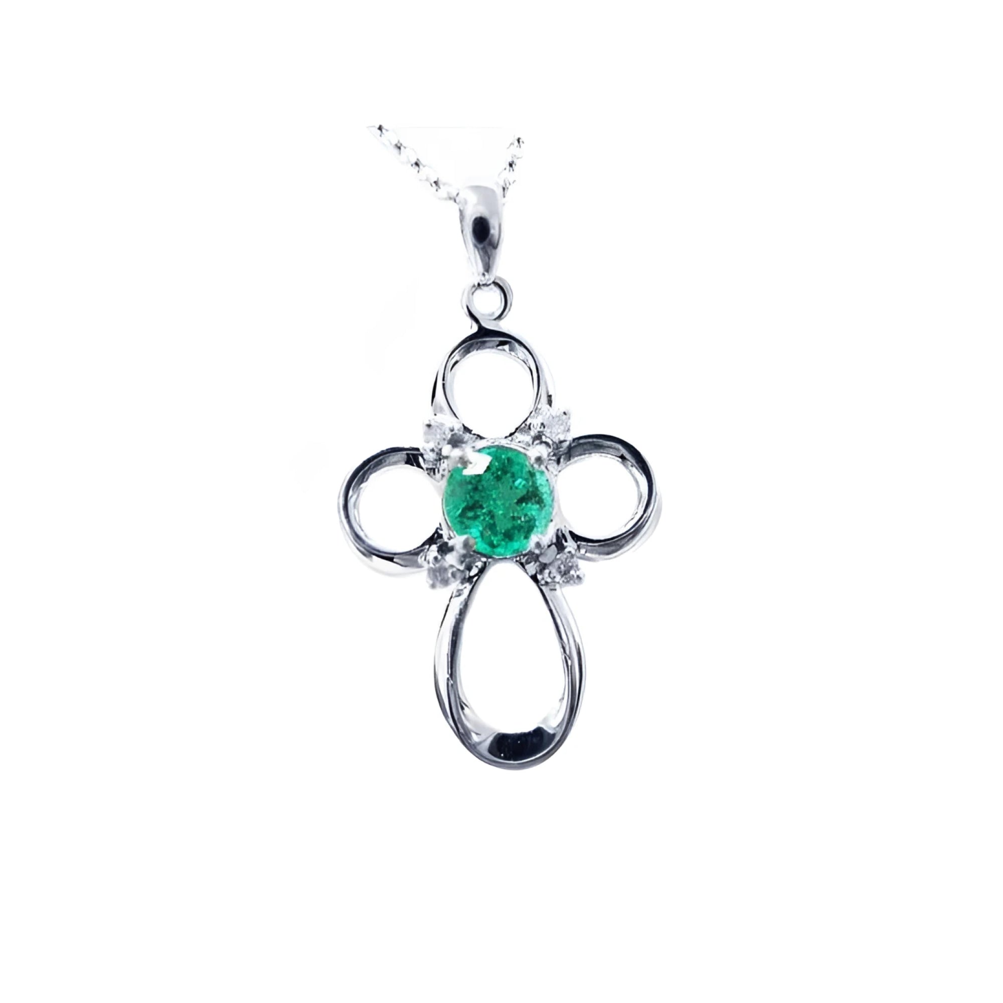 A 14k white gold emerald cross pendant necklace, displaying the topside view.