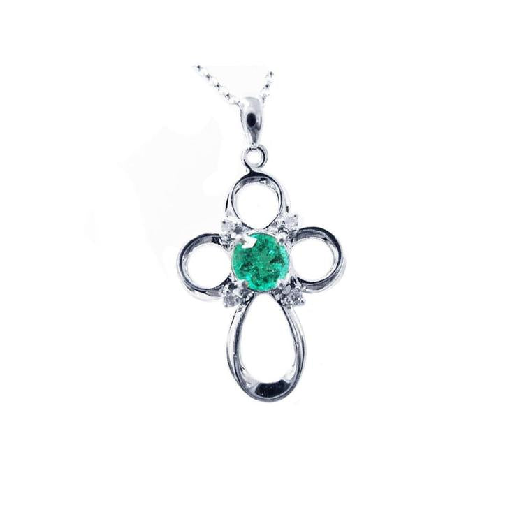 A 14k white gold emerald cross pendant necklace, displaying the topside view.