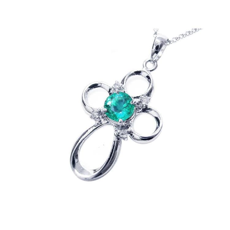A 14k white gold emerald pendant necklace showing the topside profile view.
