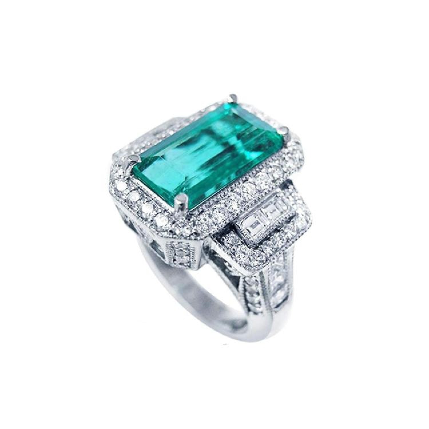 18K white gold ring with a vibrant emerald-cut Colombian emerald, haloed by diamonds and baguette side stones.