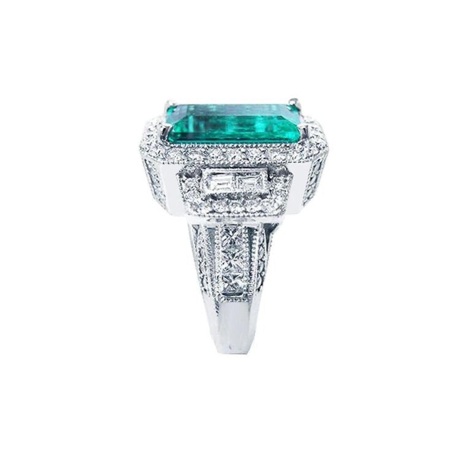 18K white gold ring with a vibrant emerald-cut Colombian emerald, haloed by diamonds and baguette side stones.