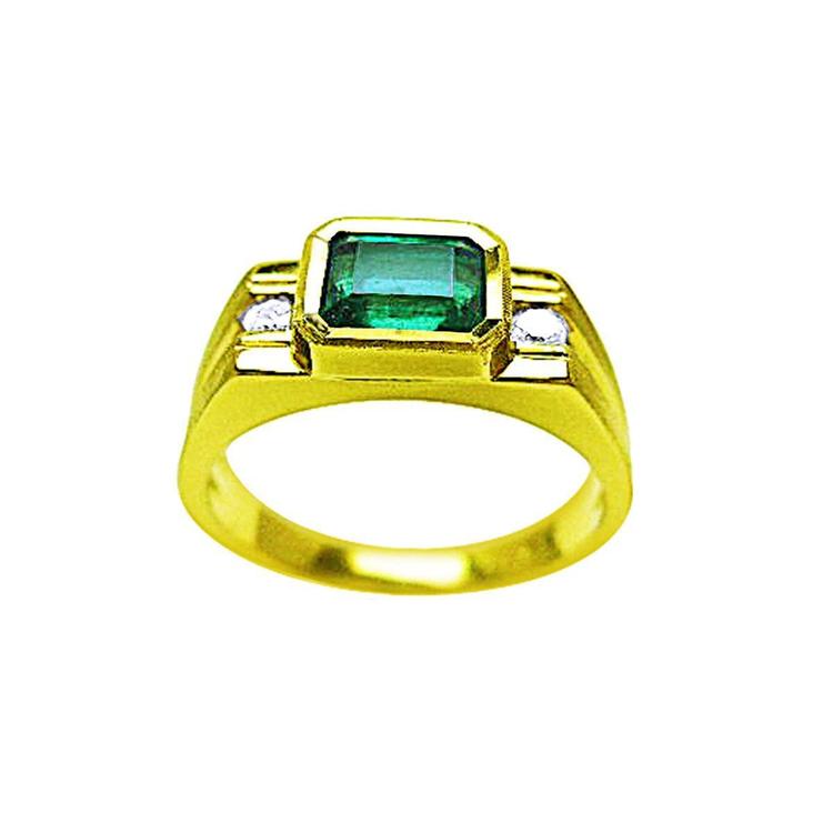 A bezel set men's emerald ring with side accent diamonds in yellow gold topside view.