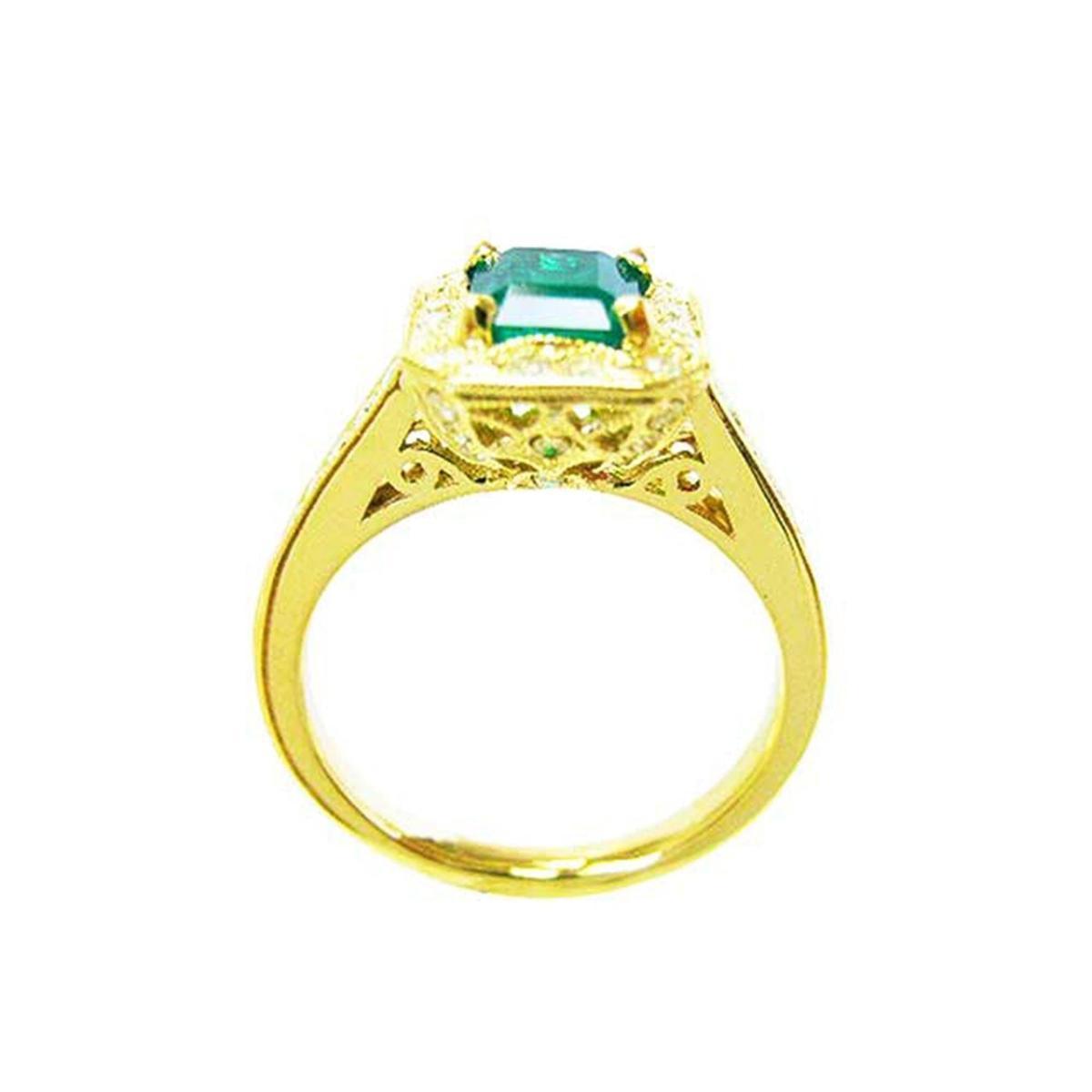 This is a yellow gold emerald ring for women on a lateral position top and gallery view.