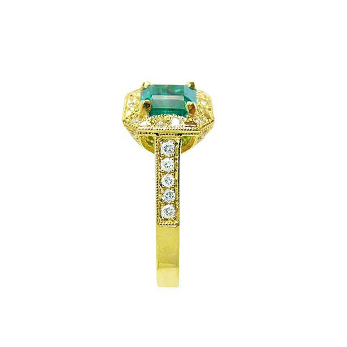 A natural emerald ring for women on top and side profile view.