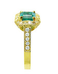 A natural emerald ring for women on top and side profile view.