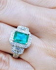 A natural emerald engagement ring white gold on a hand.