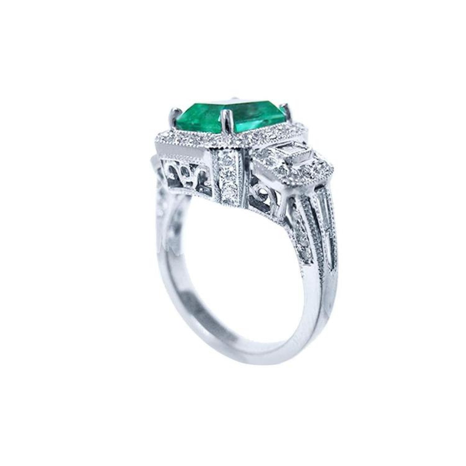 18K white gold engagement ring with a vibrant emerald, diamond halo, and baguette side diamonds.