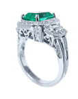 This is a halo diamond and natural emerald engagement ring on a top and downside profile display.