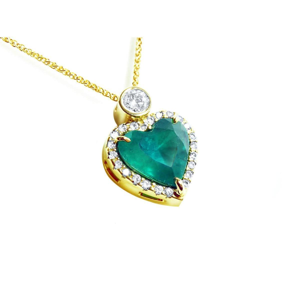 Heart-shaped natural Colombian emerald pendant with gold border and small halo diamond, topside view.