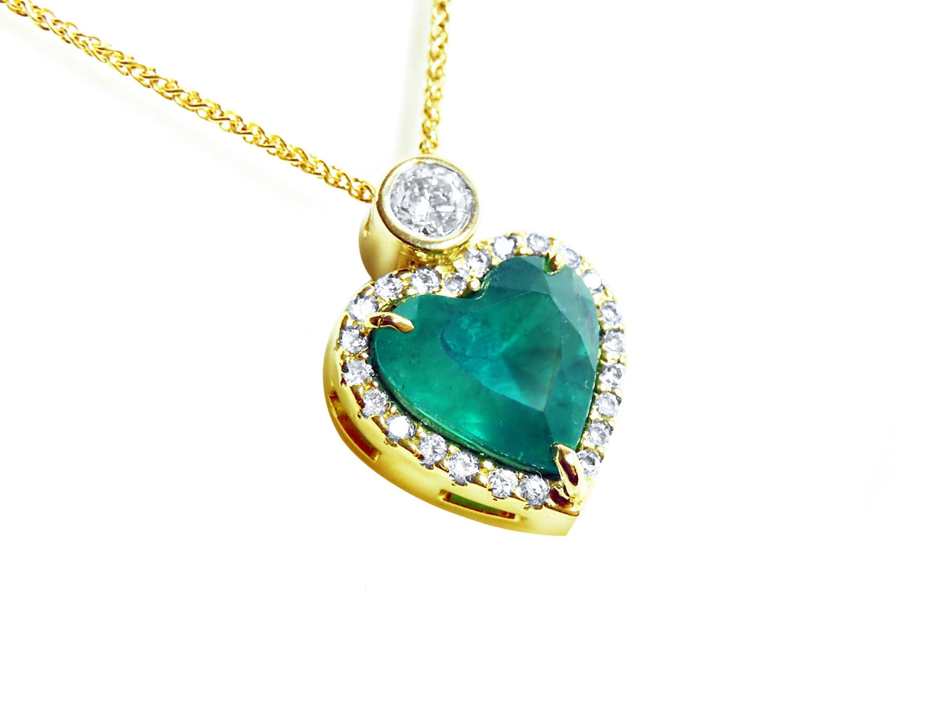 Heart-shaped natural Colombian emerald pendant with gold border and small halo diamond, topside view.