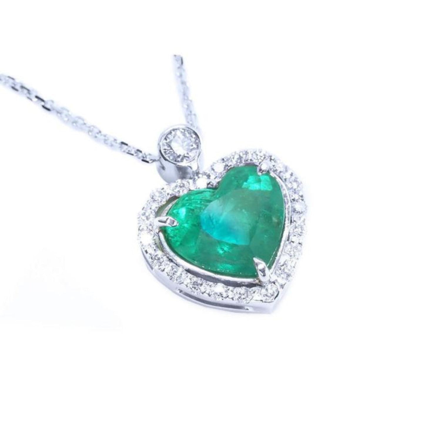 Heart-shaped natural emerald pendant with halo diamond accents made of 14k white gold.