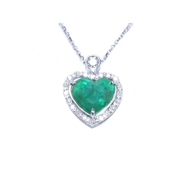 Heart-shaped emerald pendant on a topside view front position, halo diamond visible.