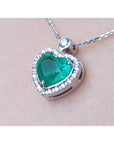 2.64 ct natural emerald heart pendant in 14K white gold, framed by diamonds on a delicate chain.