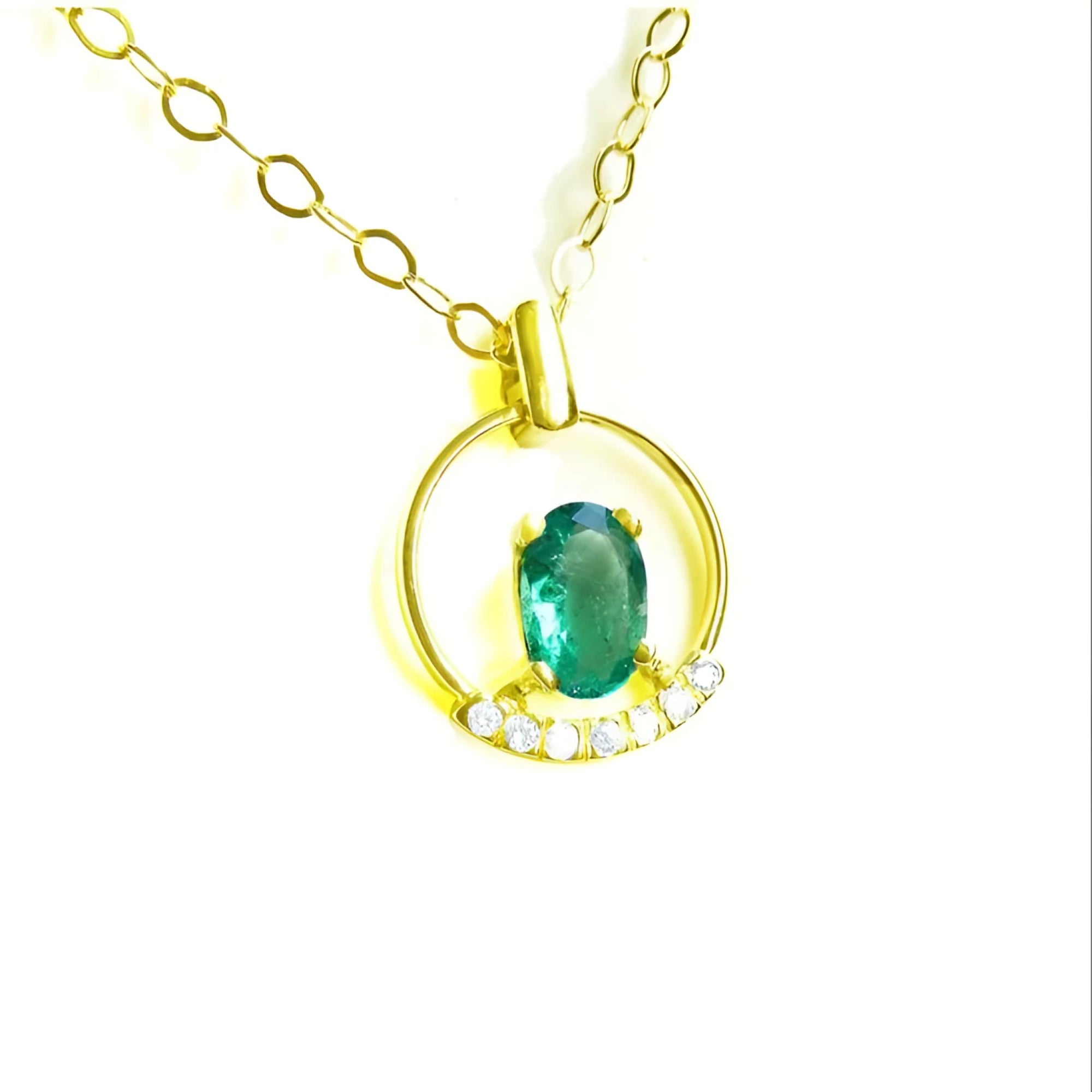 Oval cut natural colombian emerald in 14k yellow gold necklace with diamonds.