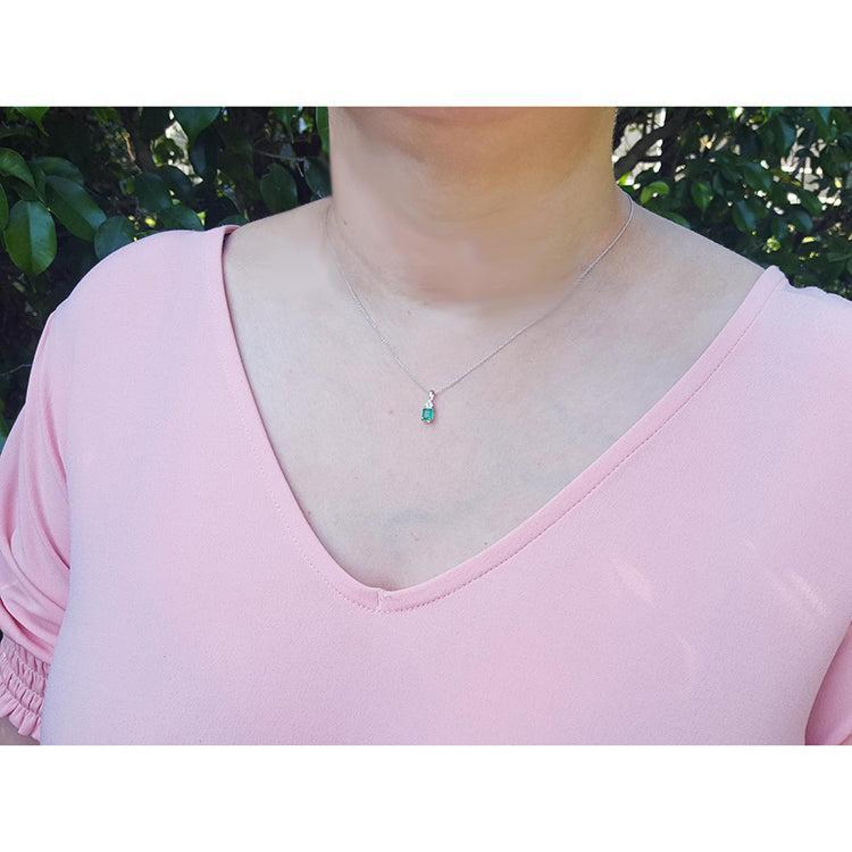 0.27 ct emerald pendant necklace in 14K white gold, worn on a model.