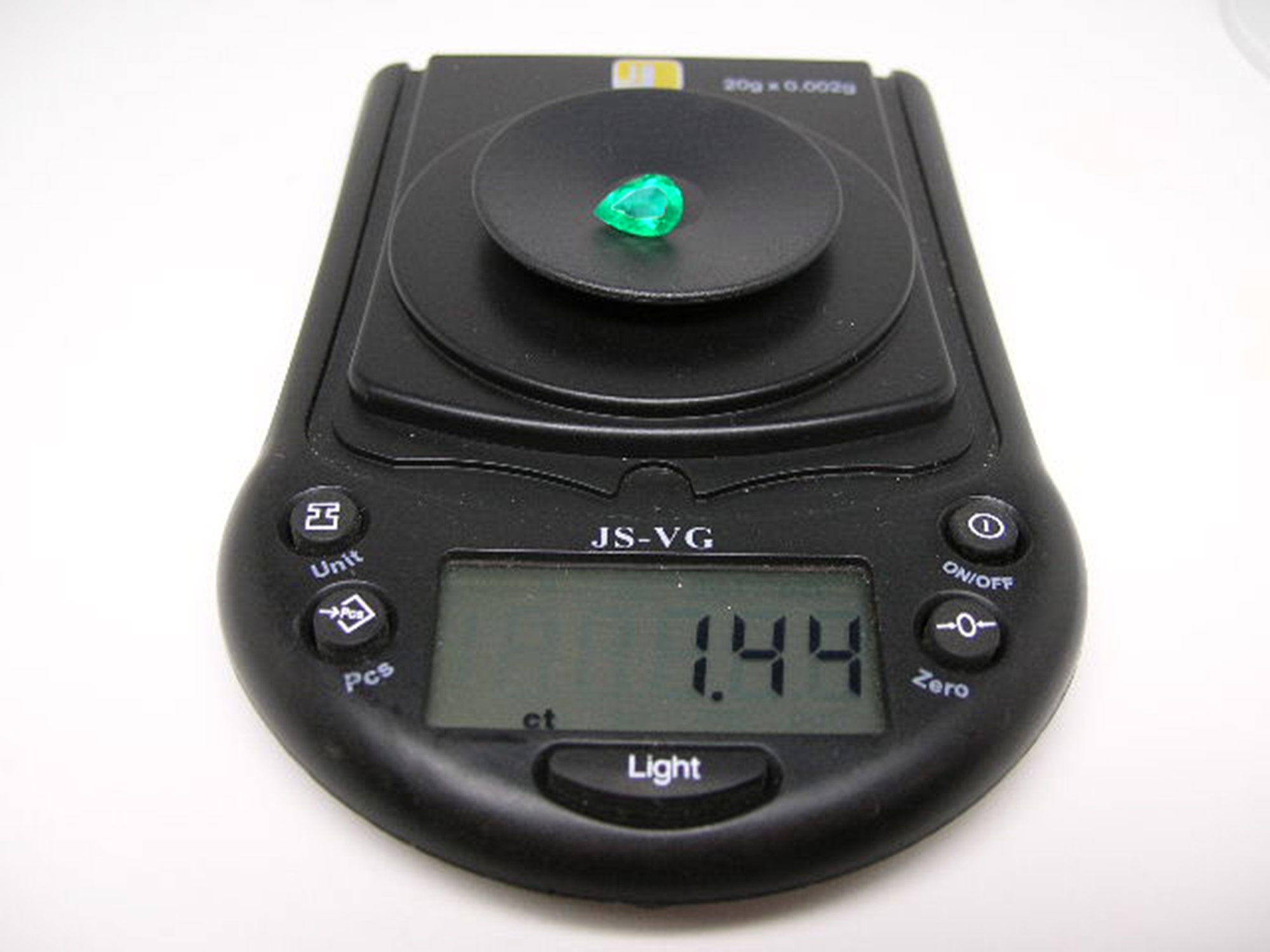Natural colombian emerald pear cut on a digital scale showing it wight