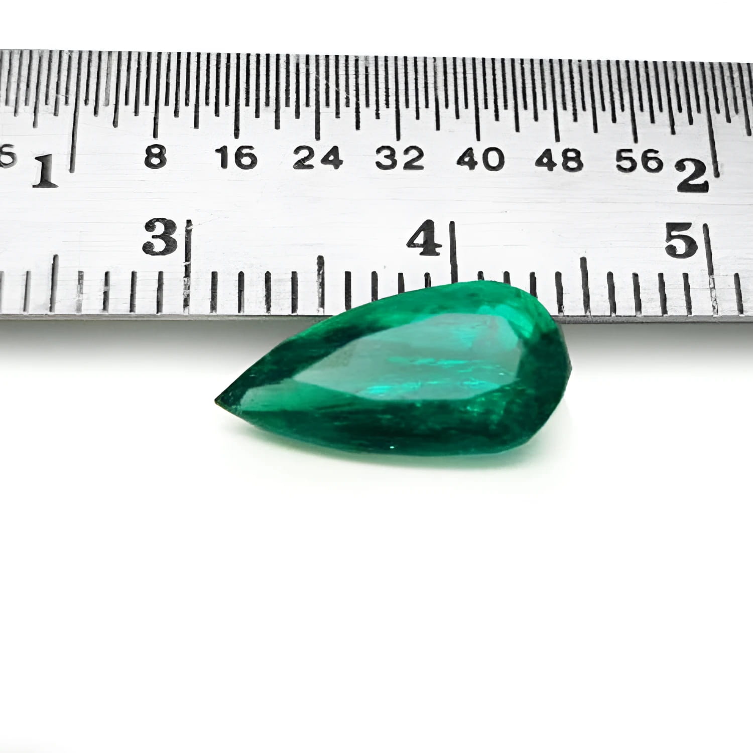 2.25 ct natural pear-cut Muzo Mine Colombian emerald, vivid bluish-green, next to a ruler.