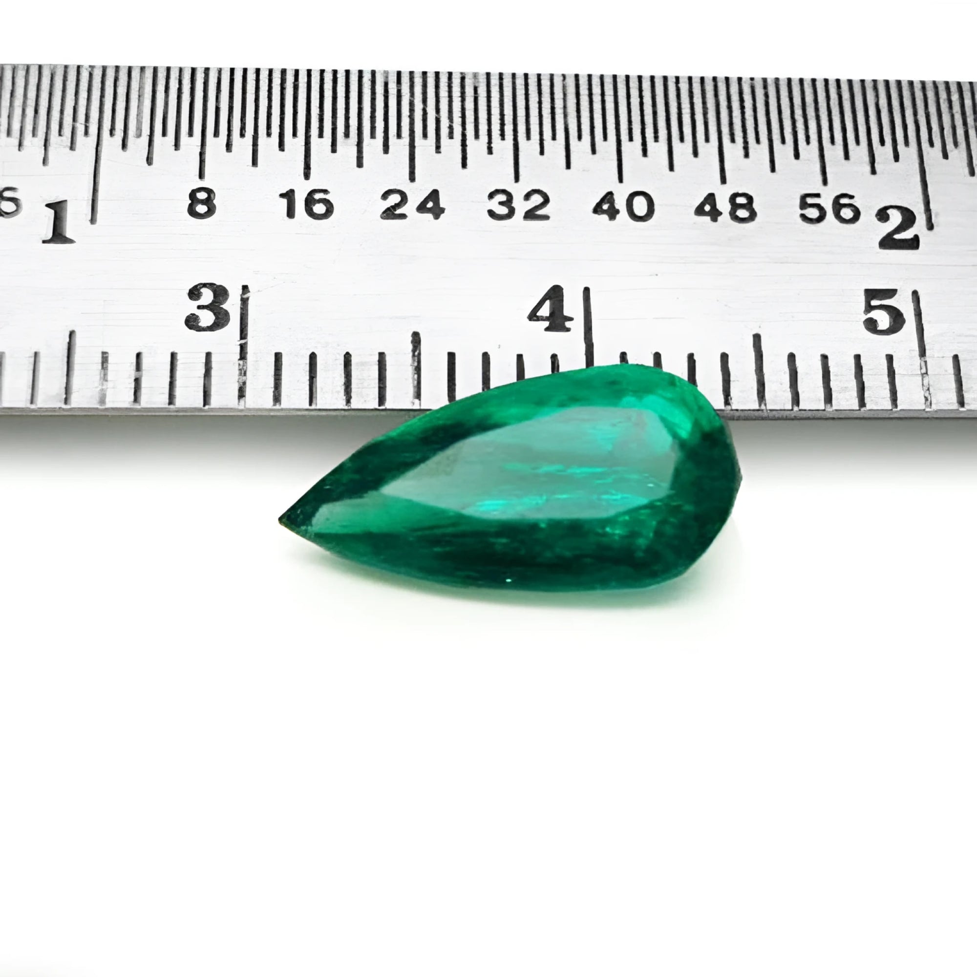 2.25 ct natural pear-cut Muzo Mine Colombian emerald, vivid bluish-green, next to a ruler.