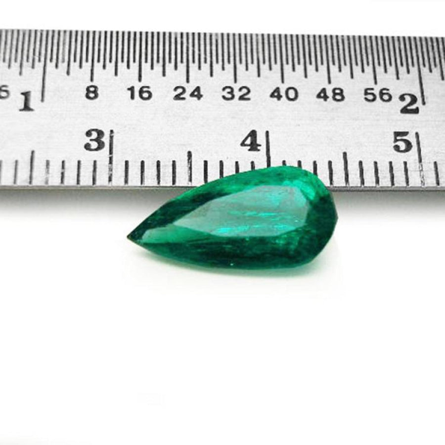 2.25 ct natural pear-cut Muzo Mine Colombian emerald, vivid bluish-green, next to a ruler.