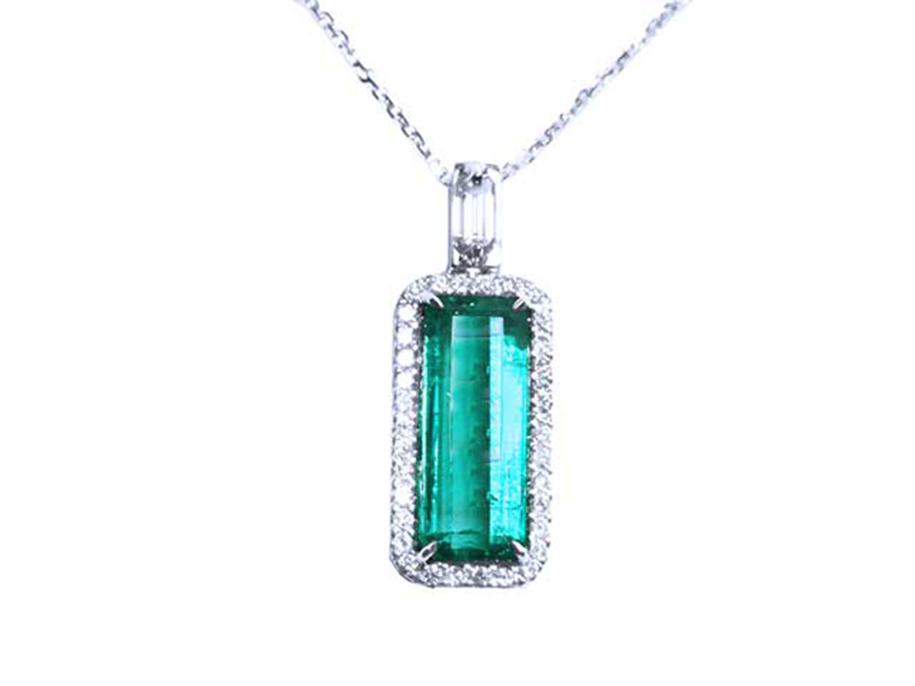 Emerald pendant necklace with a halo diamond on a white background