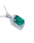 7.78 ct. deep green rectangular emerald pendant with double halo diamonds on a 14K white gold chain.