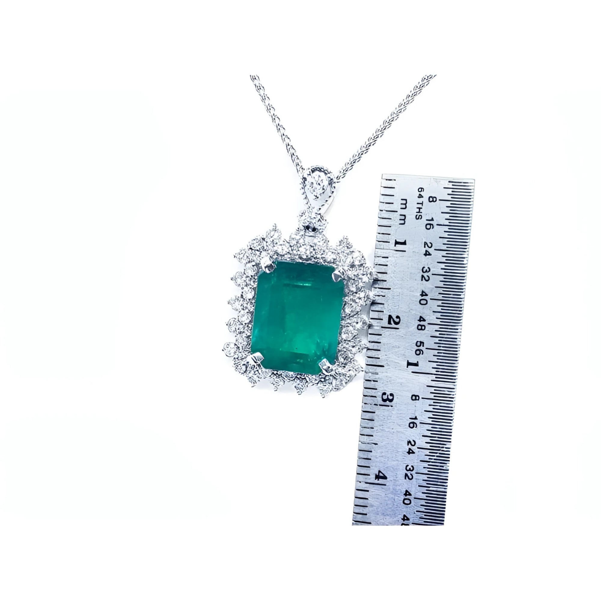 7.78 ct. rectangular natural emerald pendant with double halo diamonds in 14K white gold, shown with ruler.