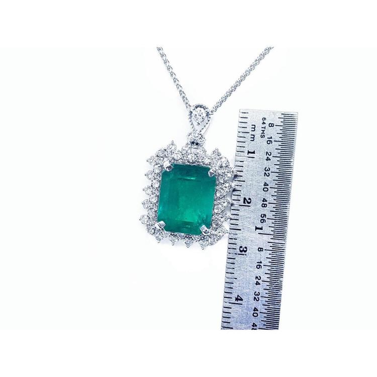 7.78 ct. rectangular natural emerald pendant with double halo diamonds in 14K white gold, shown with ruler.