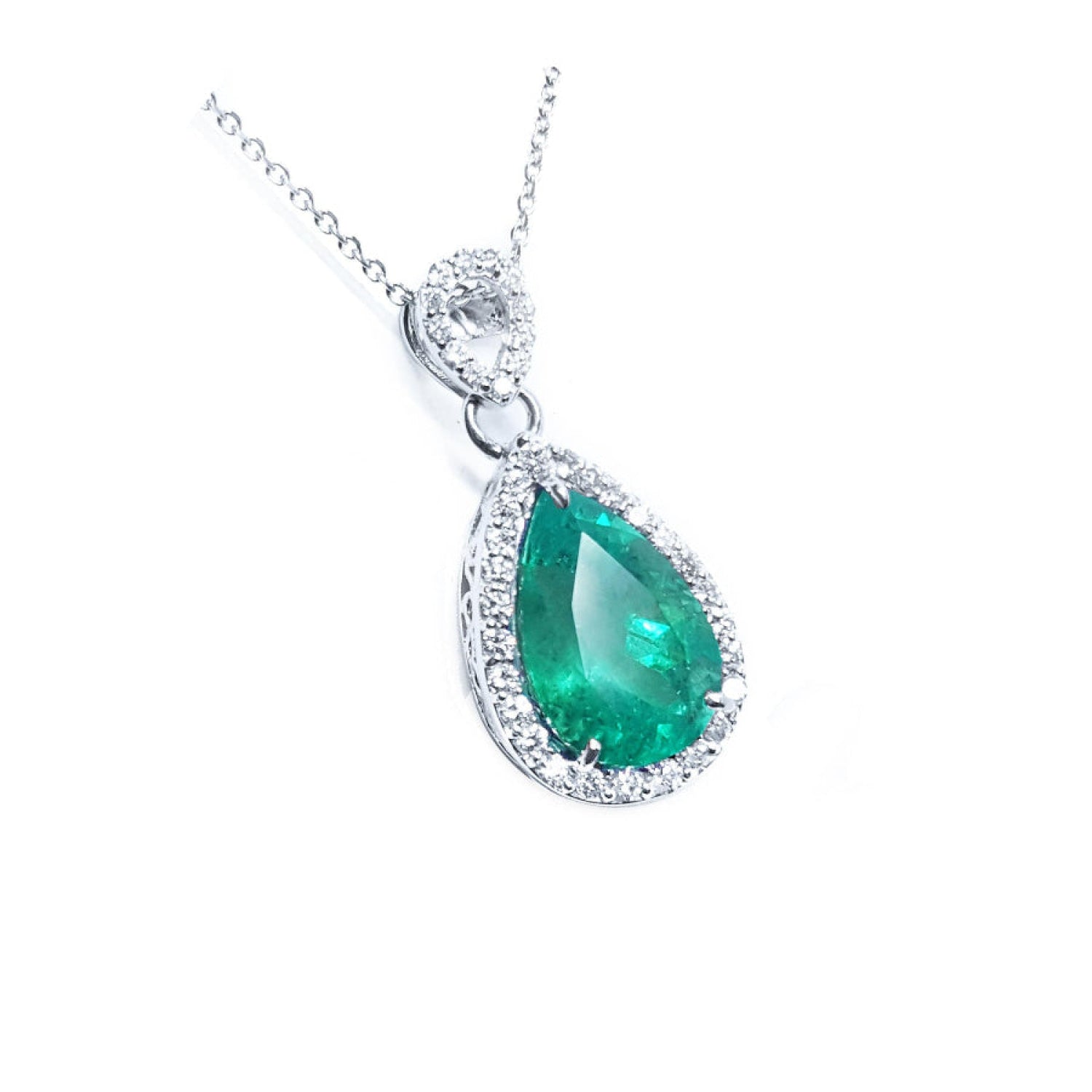 Pear-cut Colombian emerald pendant with diamond halo, set in 18K white gold.