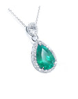 Pear-cut Colombian emerald pendant with diamond halo, set in 18K white gold.