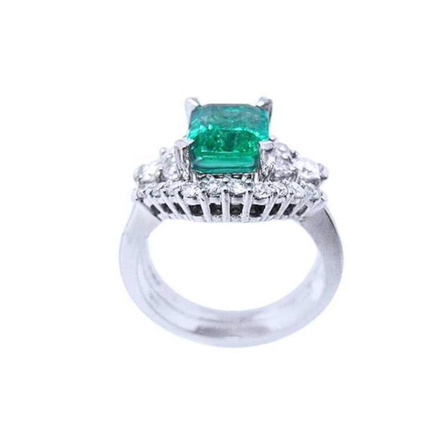 Emerald-cut vivid bluish green emerald ring in white gold, flanked by diamonds.