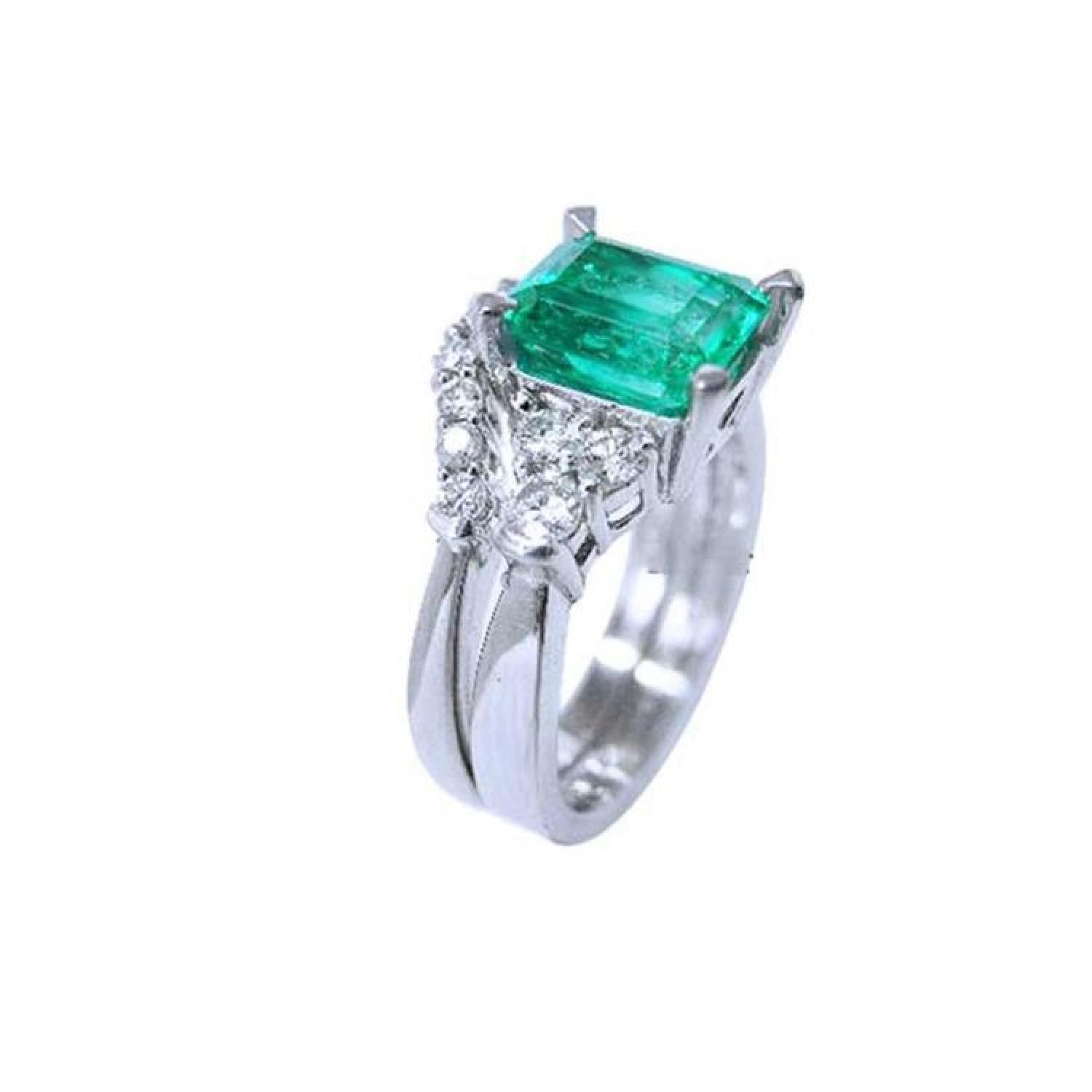 Emerald-cut vivid green emerald ring with matching band in 14K white gold, flanked by diamonds.