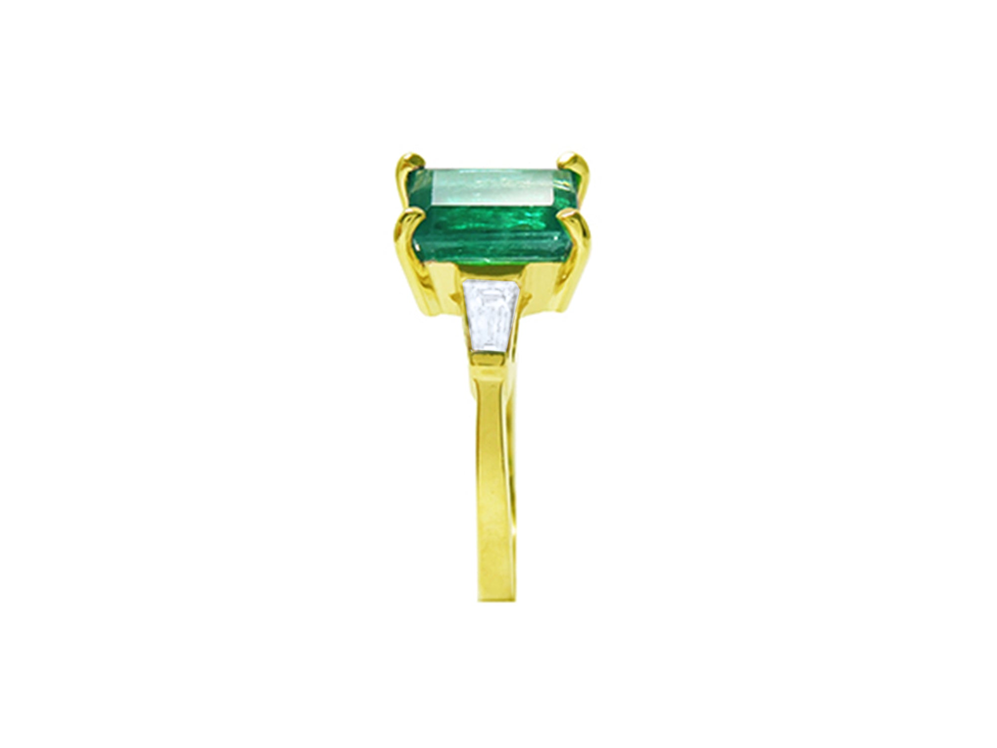 
the side profile of this colombian emerald ring shows the side top and band profile on a white background.