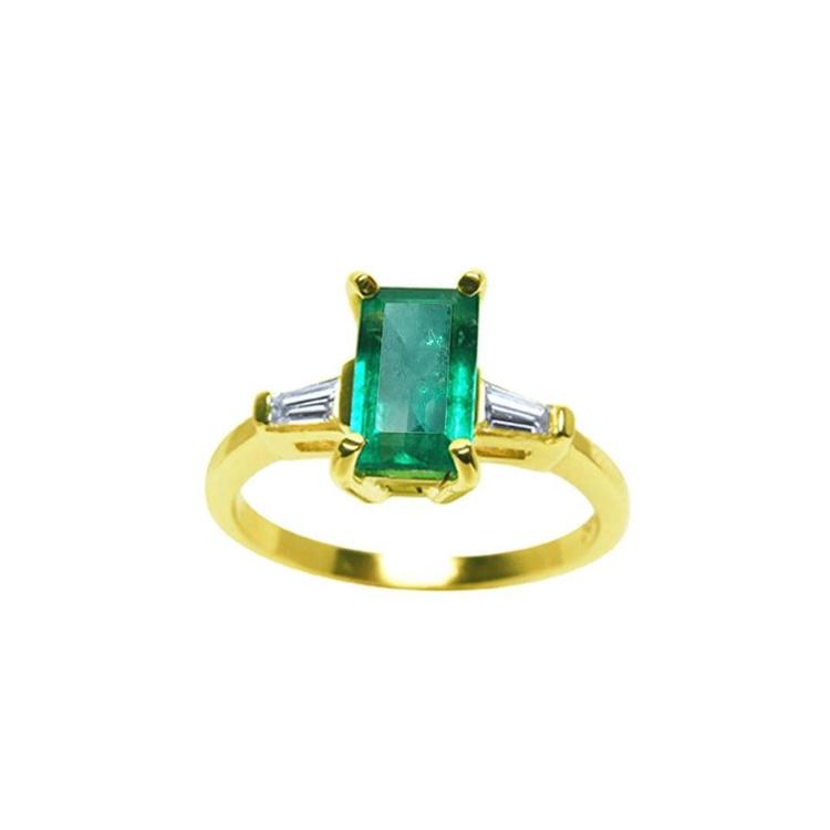 14k yellow gold ring with a center colombian emerald and two side baguette diamonds.