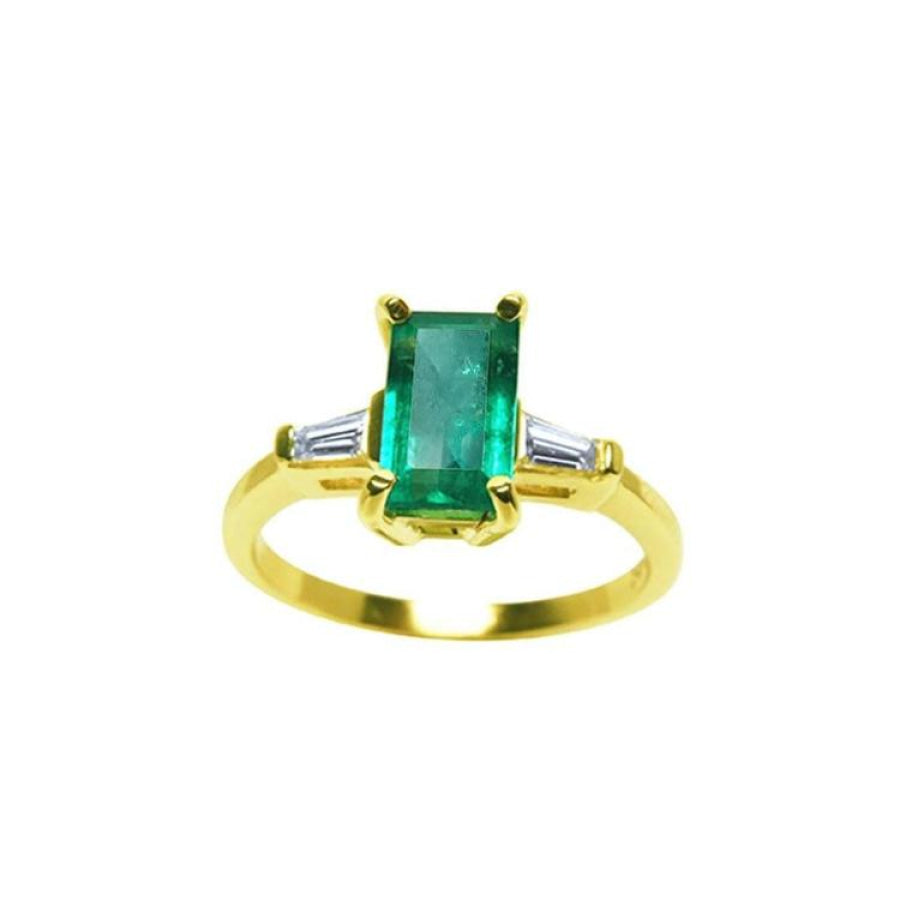 14k yellow gold ring with a center colombian emerald and two side baguette diamonds.