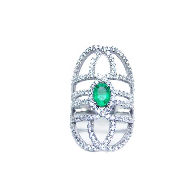 Silver ring with a genuine emerald on a white background.