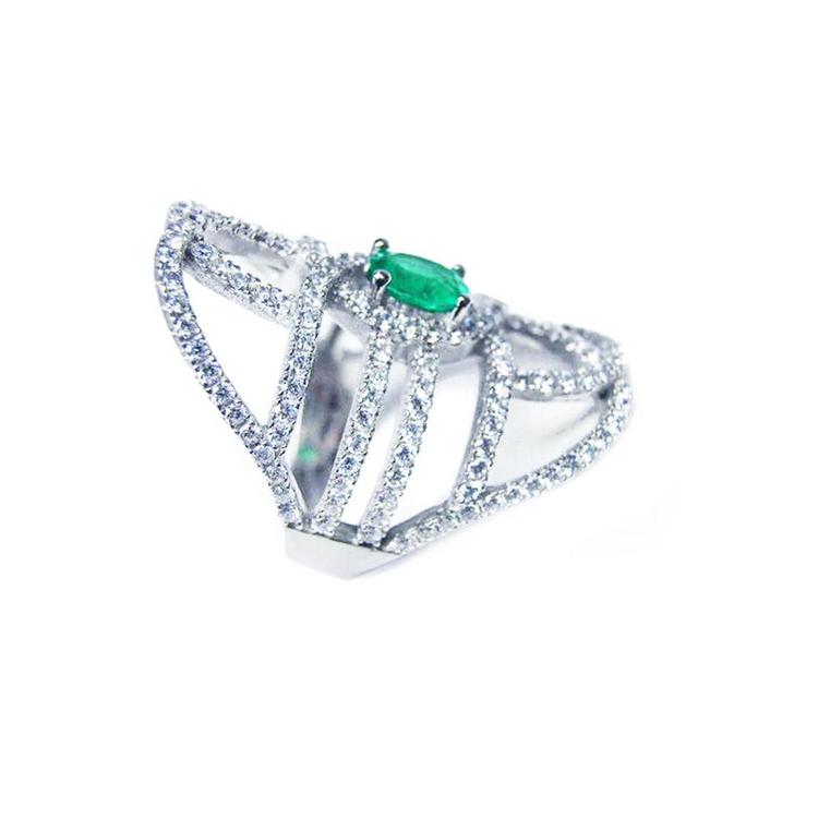 A silver ring with natural emerald center stone and diamond accents on a white background.