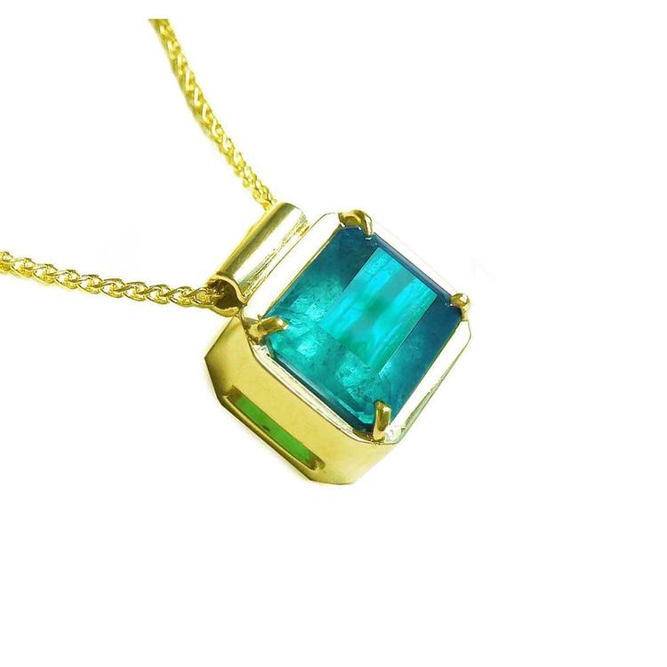 Emerald solitaire necklace east west orientation emerald-cut prong set in a handmade setting 18k yellow gold