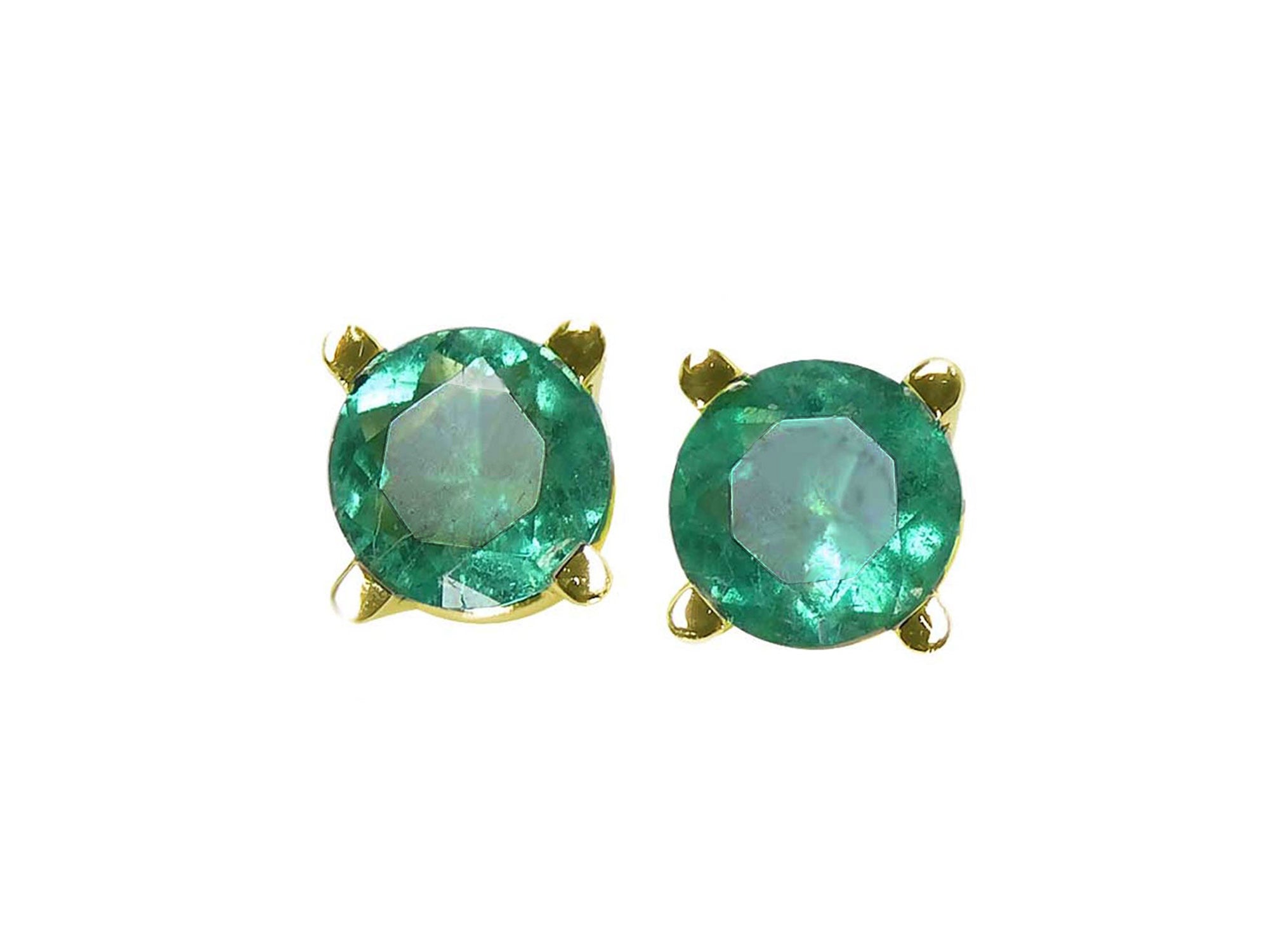 Pair of emerald stud earrings with 14k yellow gold settings on a font position top view.
