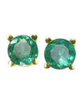Pair of emerald stud earrings with 14k yellow gold settings on a font position top view.