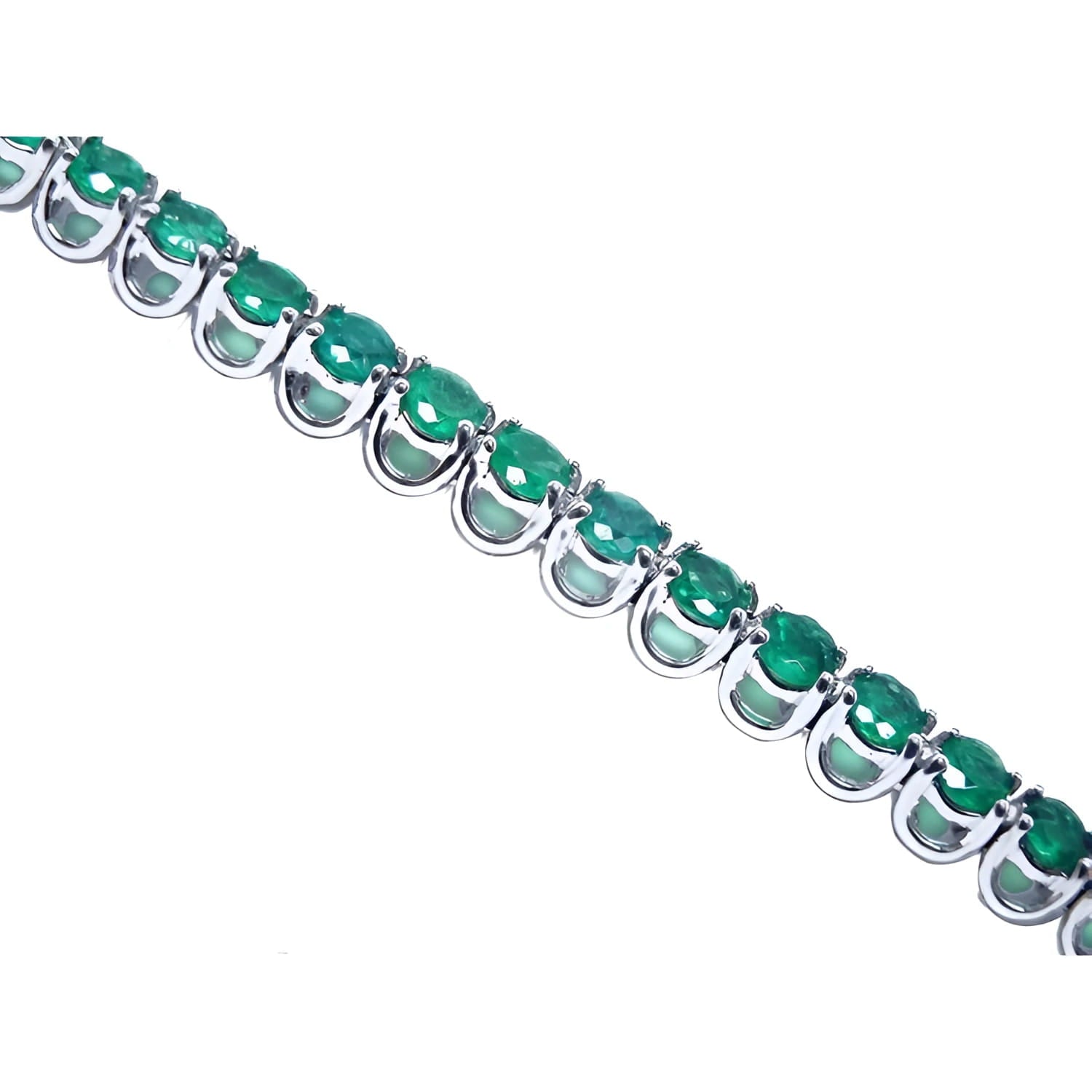 A tennis bracelet with round cut natural colombian emeralds crafted in in 14k white gold.