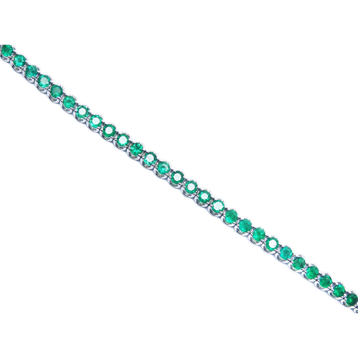 Emerald tennis bracelet topside view position on a white background.