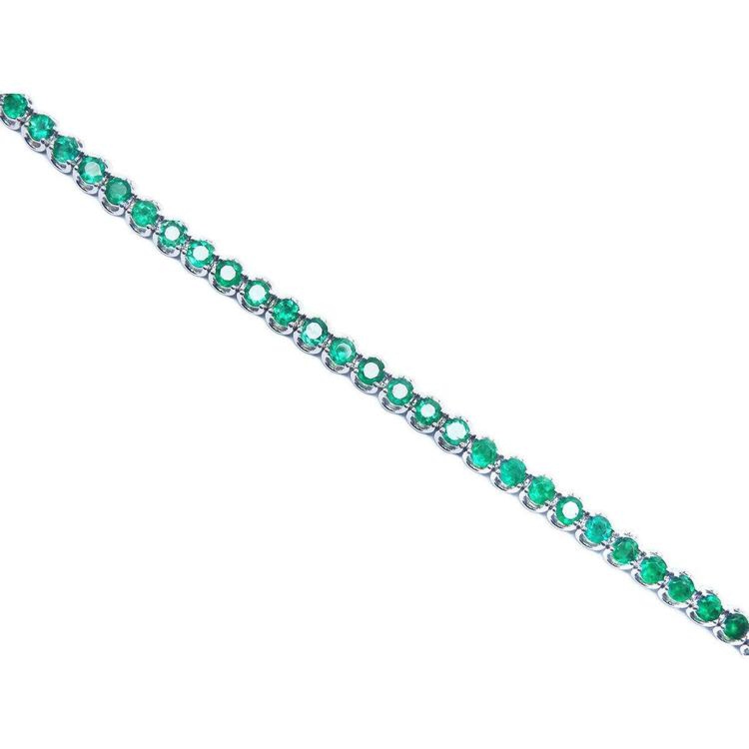 Colombian emerald tennis bracelet with round cut, deep green emeralds in 14K white gold.