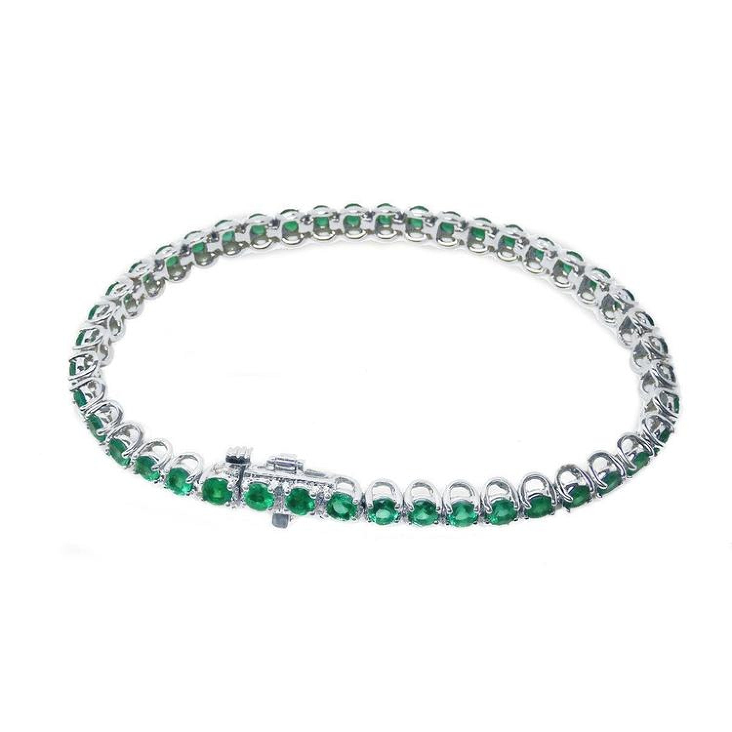 Colombian emerald tennis bracelet with round, deep green emeralds in 14K white gold.