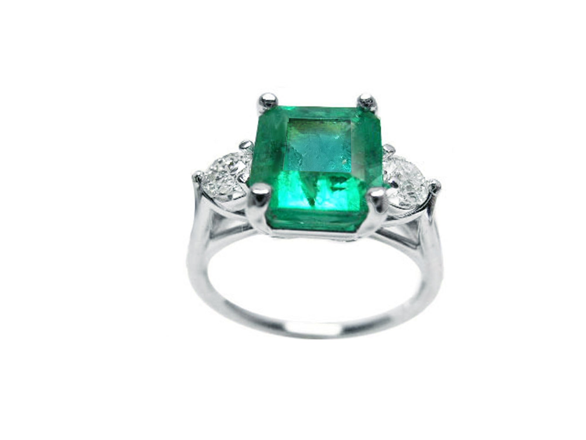 A white gold square emerald ring with side diamonds on a white background.