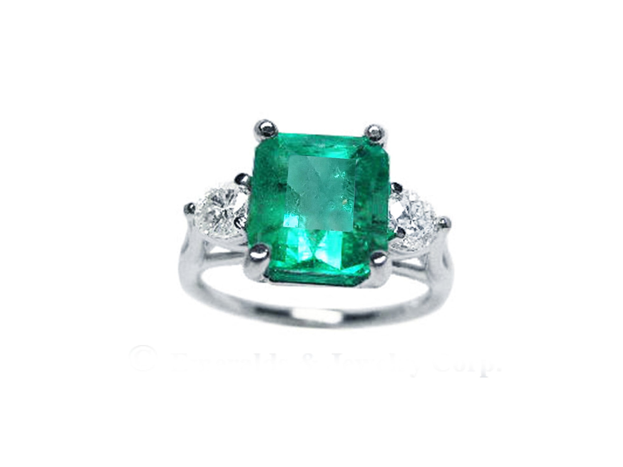 The front side of this emerald three stone ring shows the top side with side diamonds profile.