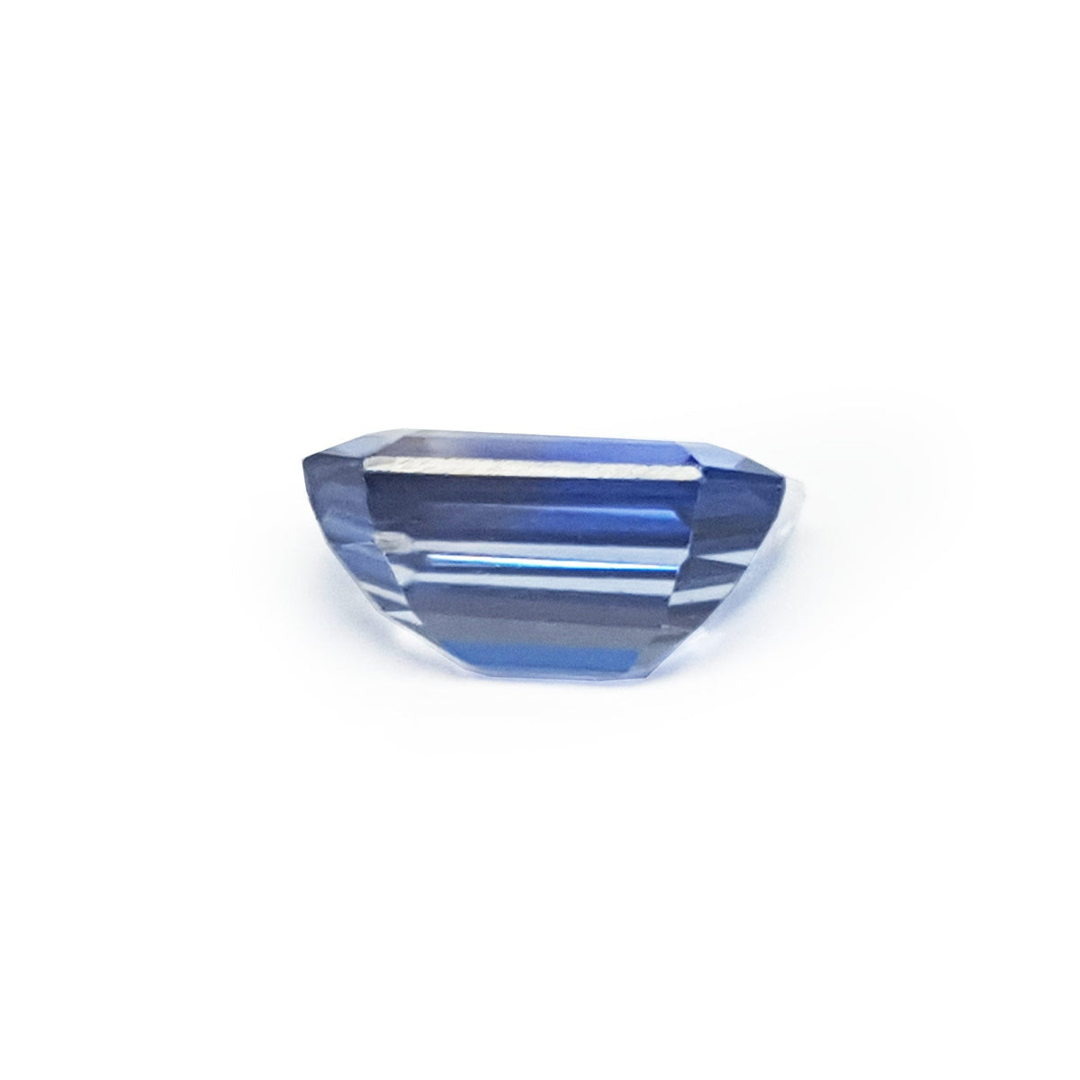 Natural loose sapphire emerald-cut, underside position girdle and pavilion visibles