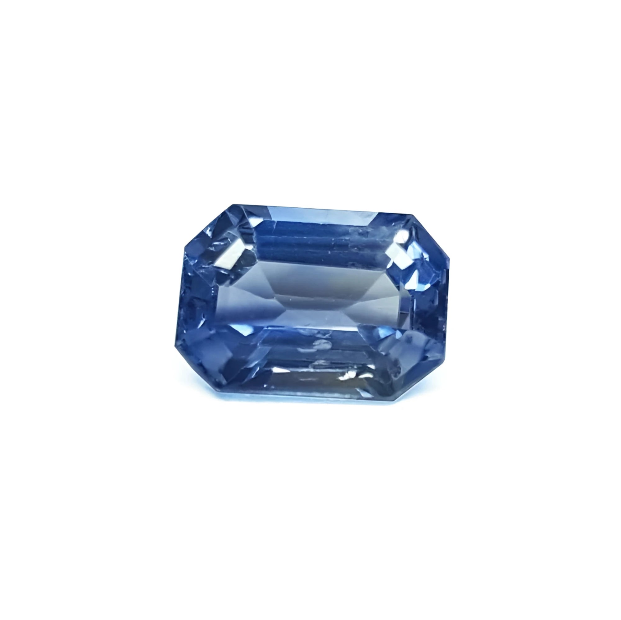 Natural loose sapphire emerald-cut, a vibrant medium blue hue gemstone with exceptional light reflection. 