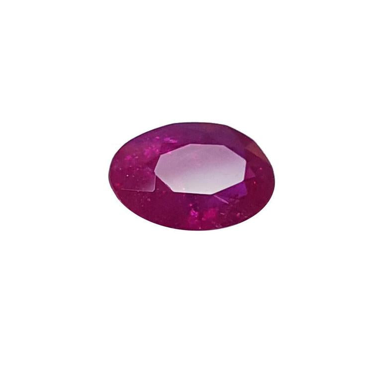 2.12 carat loose natural ruby, rich red oval cut gemstone with sparkling facets.