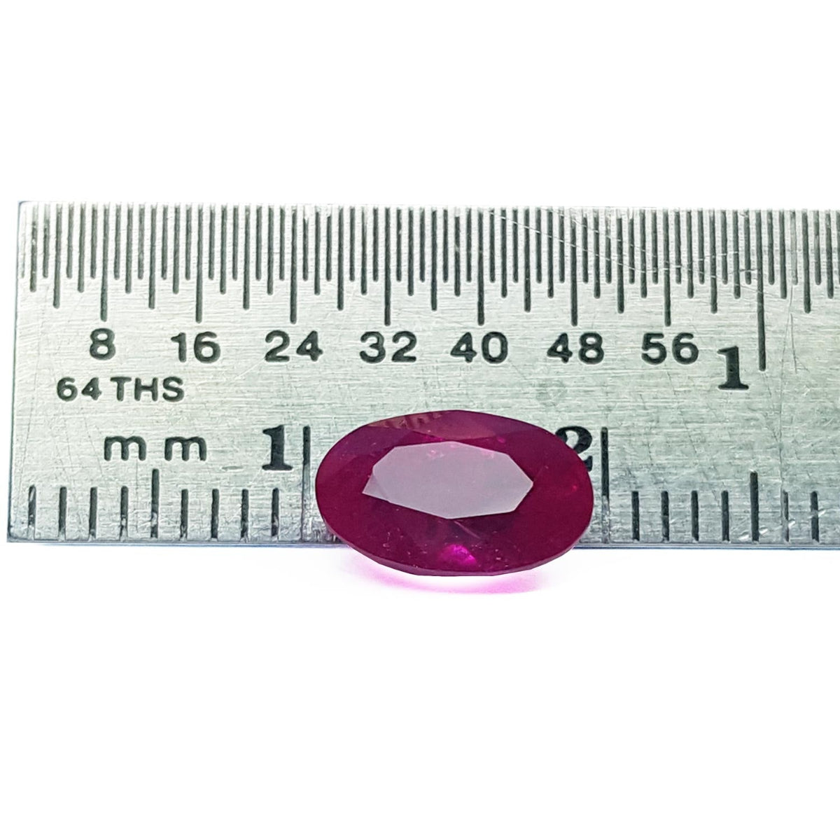 Loose natural ruby oval cut certified, front side table and crown are visibles with a ruler sizer